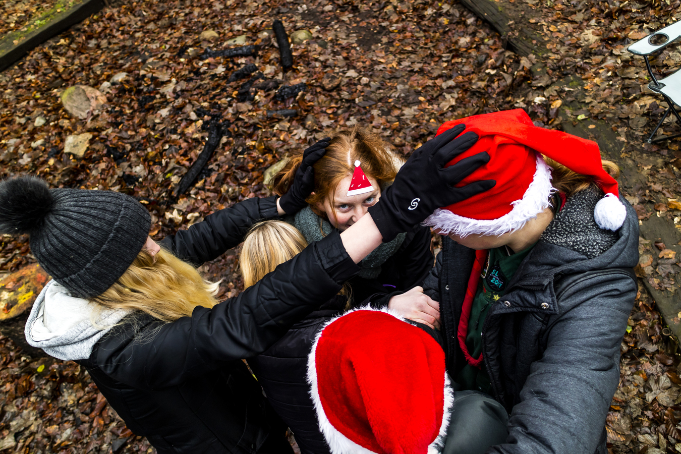 Spejdere der leger med nissehuer på i en skov